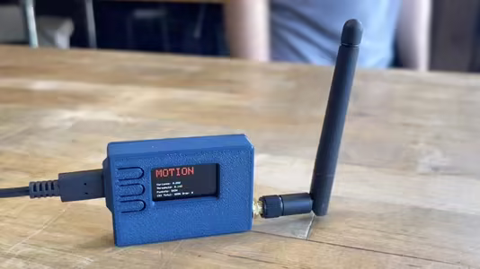 Adafruit Feather ESPectre detector showing motion on its display